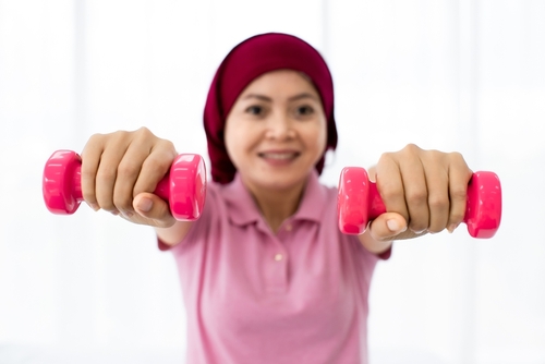 Lively,Cutout,Of,Pink,Plastic,Dumbbell,Grabbed,By,Hands,Of